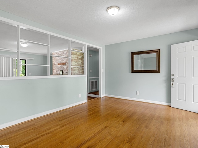 221 N Hill Dr, Boiling Springs, SC 29316 - empty room featuring wood finished floors, baseboards, and a textured ceiling