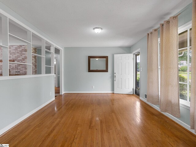 221 N Hill Dr, Boiling Springs, SC 29316 - spare room featuring wood finished floors, baseboards, and a textured ceiling