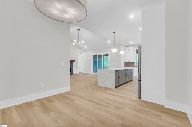 120 Thomason View Rd, Fountain Inn, SC 29644 - kitchen with light countertops, light wood-style flooring, a kitchen island, open floor plan, and hanging light fixtures