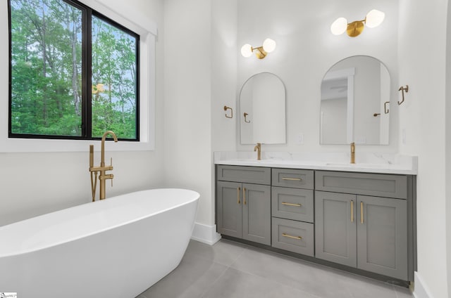 120 Thomason View Rd, Fountain Inn, SC 29644 - bathroom with double vanity, a freestanding tub, and baseboards