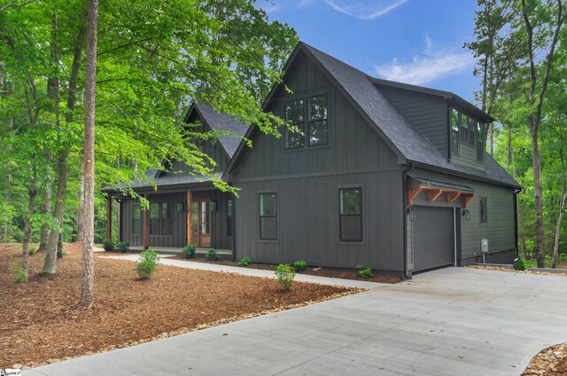 120 Thomason View Rd, Fountain Inn, SC 29644 - view of front of home with covered porch, a garage, roof with shingles, and concrete driveway