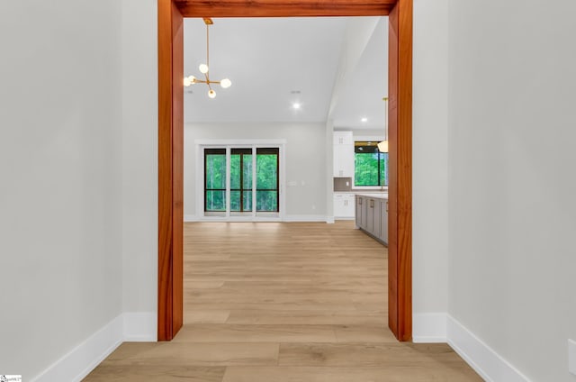 120 Thomason View Rd, Fountain Inn, SC 29644 - corridor featuring a chandelier, light wood-style floors, and baseboards