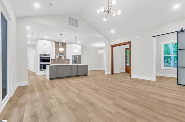 120 Thomason View Rd, Fountain Inn, SC 29644 - kitchen featuring appliances with stainless steel finishes, white cabinets, decorative backsplash, light countertops, and wall chimney range hood