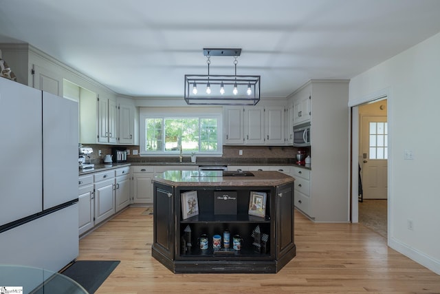 251 Williams Rd, Pelzer, SC 29669 - kitchen featuring freestanding refrigerator, decorative backsplash, stainless steel microwave, and dark countertops