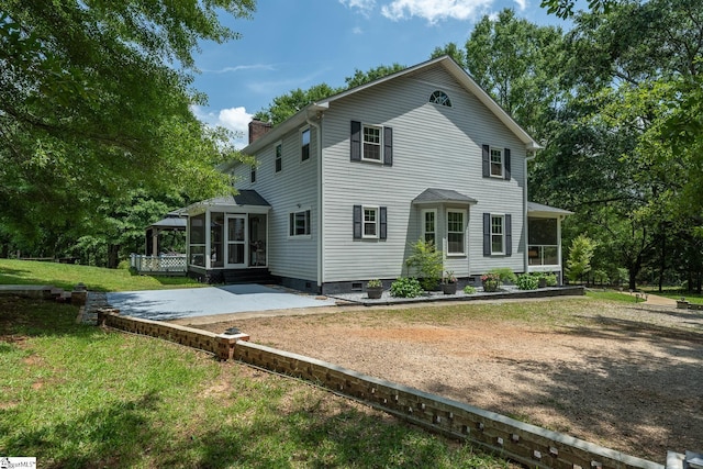 251 Williams Rd, Pelzer, SC 29669 - rear view of property with a sunroom, a patio, a chimney, and a yard