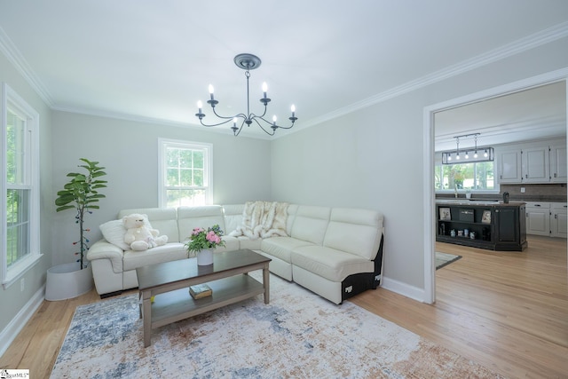 251 Williams Rd, Pelzer, SC 29669 - living room featuring healthy amount of natural light, a chandelier, light wood-style flooring, crown molding, and baseboards