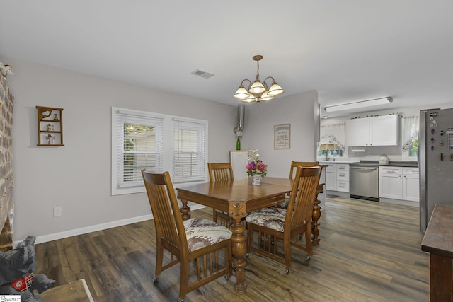 2444 Abner Creek Rd, Duncan, SC 29334 - dining area with a chandelier, dark wood-type flooring, and baseboards