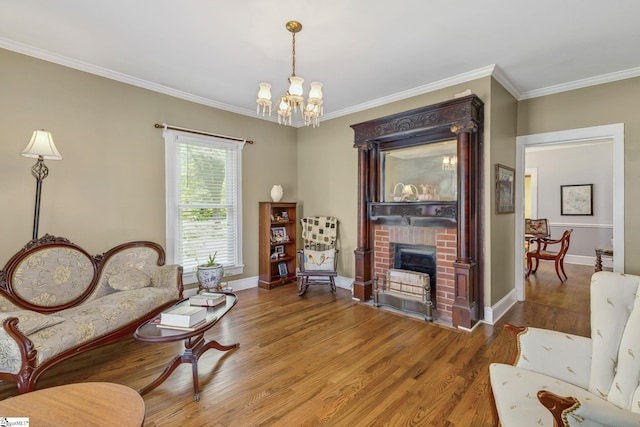 600 Gulliver St, Fountain Inn, SC 29644 - living area with a brick fireplace, a chandelier, wood finished floors, ornamental molding, and baseboards