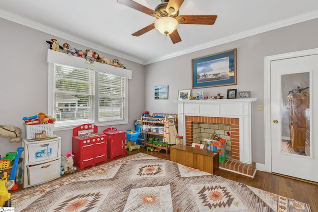 600 Gulliver St, Fountain Inn, SC 29644 - rec room featuring hardwood / wood-style floors, crown molding, a ceiling fan, a fireplace, and baseboards