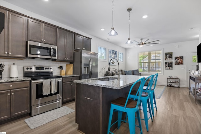 508 W D Ave, Easley, SC 29640 - kitchen with stainless steel appliances, a sink, light wood finished floors, dark brown cabinetry, and recessed lighting