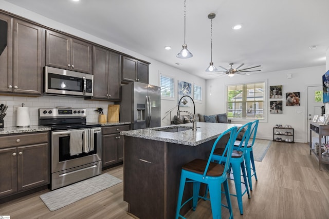 508 W D Ave, Easley, SC 29640 - kitchen featuring appliances with stainless steel finishes, a sink, light wood-type flooring, dark brown cabinetry, and recessed lighting