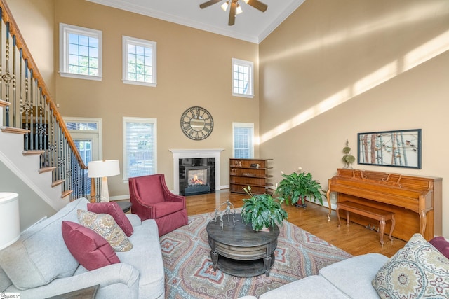 204 Whitworth Way, Simpsonville, SC 29681 - living room featuring high vaulted ceiling, ceiling fan, stairs, wood finished floors, and crown molding