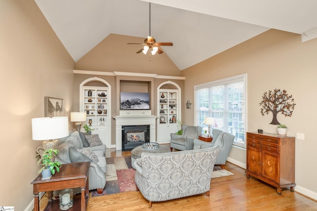 204 Whitworth Way, Simpsonville, SC 29681 - living room with ceiling fan, a glass covered fireplace, light wood-style floors, high vaulted ceiling, and baseboards