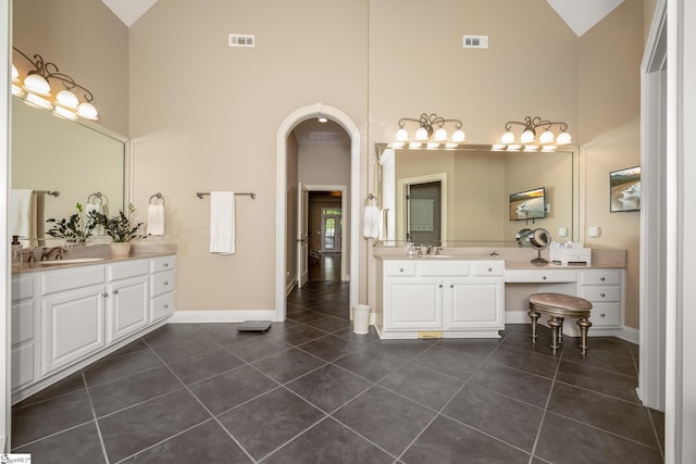 204 Whitworth Way, Simpsonville, SC 29681 - bathroom with high vaulted ceiling, tile patterned flooring, baseboards, and two vanities