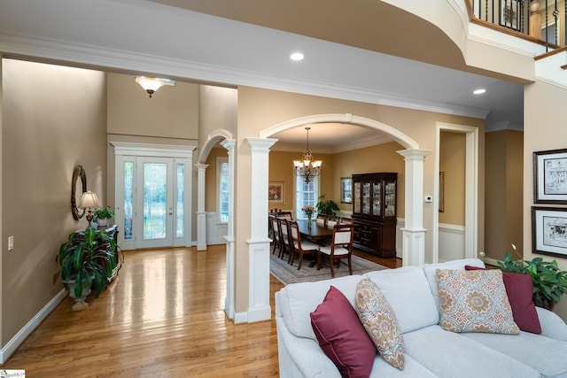 204 Whitworth Way, Simpsonville, SC 29681 - living area featuring arched walkways, decorative columns, light wood-type flooring, healthy amount of natural light, and crown molding