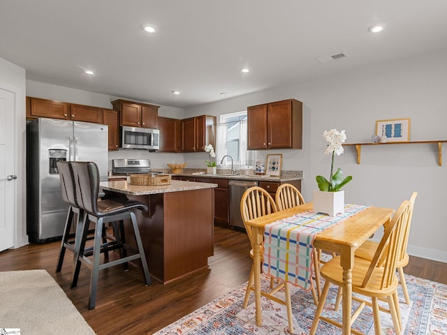 514 Olivia Springs Dr, Spartanburg, SC 29302 - kitchen featuring stainless steel appliances, a center island, dark wood finished floors, recessed lighting, and light stone counters