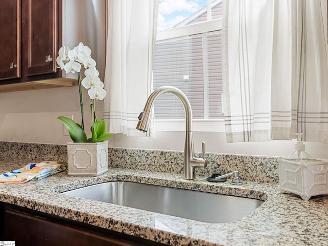 514 Olivia Springs Dr, Spartanburg, SC 29302 - kitchen view of a sink, dark brown cabinetry, and light stone counters