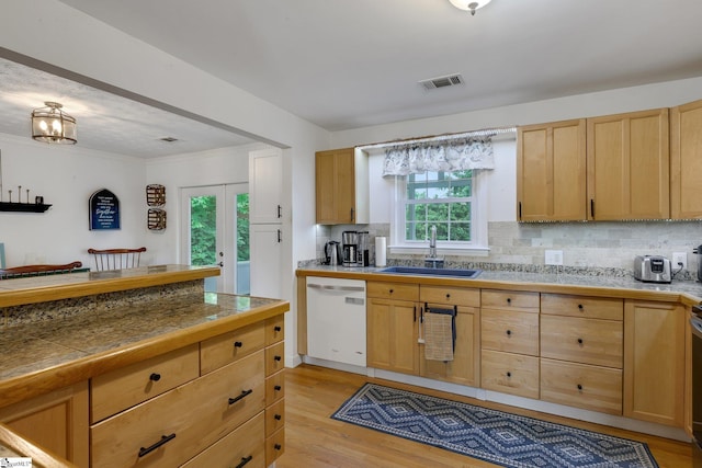 4600 Coach Hill Dr, Greenville, SC 29615 - kitchen with a sink, white dishwasher, light brown cabinetry, tasteful backsplash, and light wood-style flooring