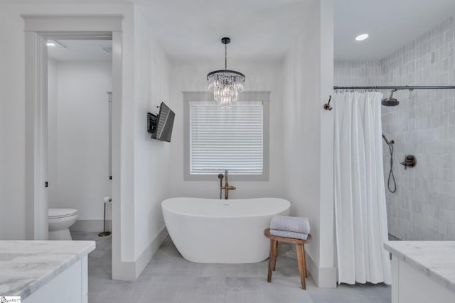 320 Terry Rd, Fountain Inn, SC 29644 - bathroom featuring a soaking tub, baseboards, tiled shower, a chandelier, and toilet
