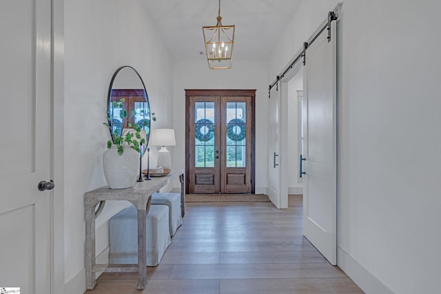 320 Terry Rd, Fountain Inn, SC 29644 - foyer entrance with a barn door, light wood-style floors, french doors, a chandelier, and baseboards