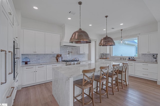 320 Terry Rd, Fountain Inn, SC 29644 - kitchen featuring a sink, backsplash, white cabinetry, a kitchen island, and recessed lighting