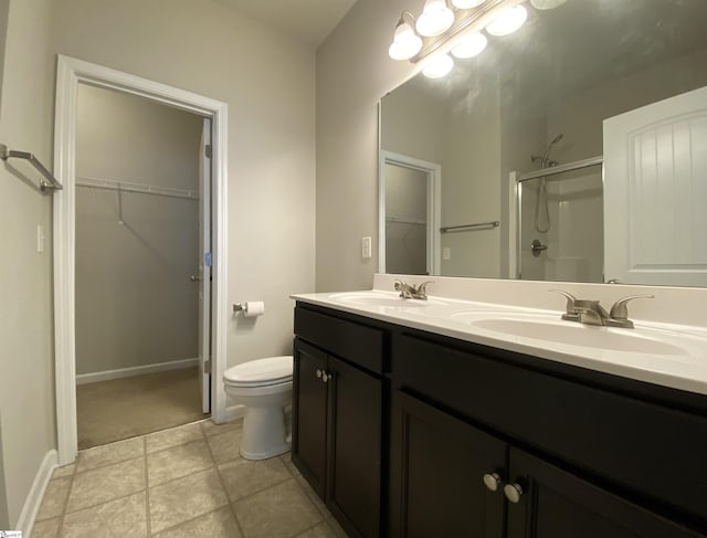110 Patagonia Rd, Anderson, SC 29625 - full bath featuring a shower stall, toilet, double vanity, a walk in closet, and baseboards