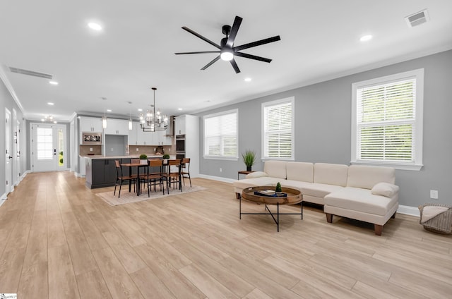 226 Deerview Trl, Simpsonville, SC 29680 - living area with a chandelier, baseboards, a ceiling fan, light wood-style flooring, and ornamental molding