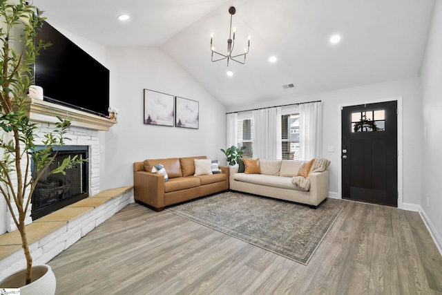 2606 Karkinnen Way, Moore, SC 29369 - living room with a chandelier, light wood-type flooring, a brick fireplace, baseboards, and recessed lighting