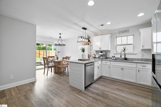2606 Karkinnen Way, Moore, SC 29369 - kitchen featuring dishwasher, a sink, a peninsula, white cabinets, and wood finished floors
