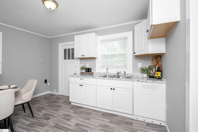 1818 Green St, Anderson, SC 29625 - kitchen with a sink, light stone counters, white cabinetry, ornamental molding, and light wood-type flooring