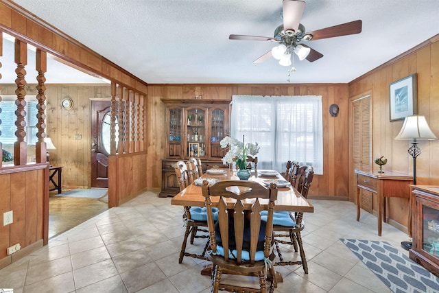 3040 Sunset Forest Rd, Anderson, SC 29626 - dining area with wood walls, a ceiling fan, light tile patterned floors, ornamental molding, and baseboards