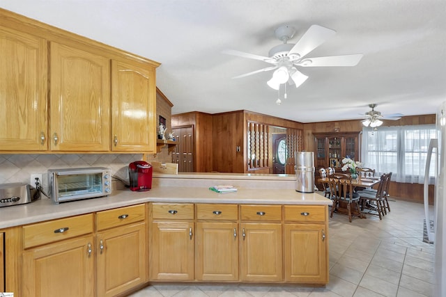 3040 Sunset Forest Rd, Anderson, SC 29626 - kitchen with a peninsula, backsplash, a ceiling fan, light countertops, and wooden walls