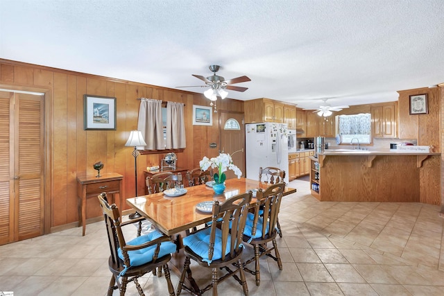 3040 Sunset Forest Rd, Anderson, SC 29626 - dining area featuring ceiling fan, wood walls, light tile patterned floors, and a textured ceiling