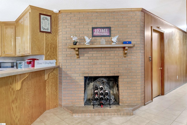 3040 Sunset Forest Rd, Anderson, SC 29626 - living area featuring a fireplace, light tile patterned flooring, wooden walls, and ornamental molding