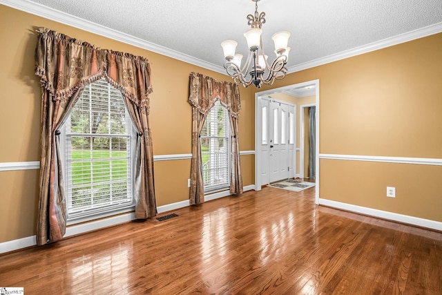 103 Farming Creek Dr, Simpsonville, SC 29680 - unfurnished room with a chandelier, plenty of natural light, baseboards, a textured ceiling, and crown molding