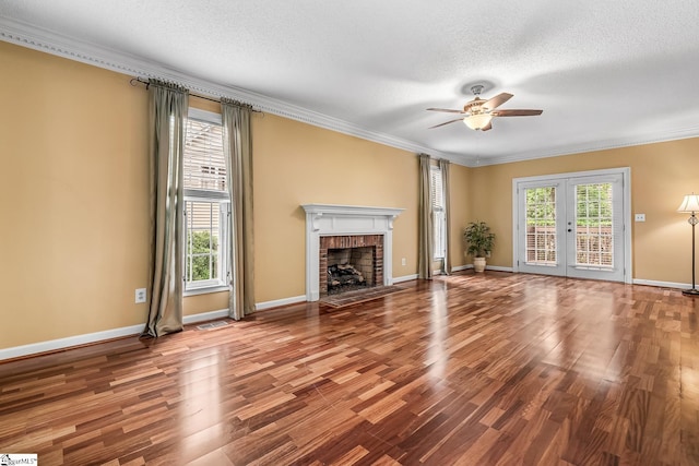 103 Farming Creek Dr, Simpsonville, SC 29680 - unfurnished living room featuring a ceiling fan, a textured ceiling, wood finished floors, a brick fireplace, and crown molding