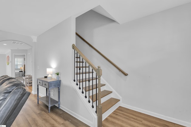 116 Bruinen Dr, Fountain Inn, SC 29644 - stairs with arched walkways, wood finished floors, and baseboards