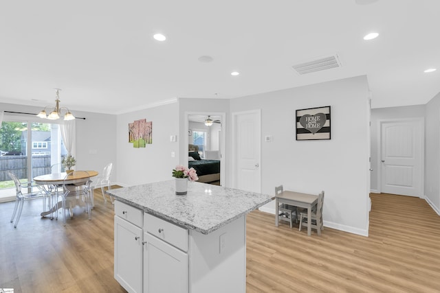 116 Bruinen Dr, Fountain Inn, SC 29644 - kitchen with light wood-style floors, a center island, white cabinets, a chandelier, and recessed lighting