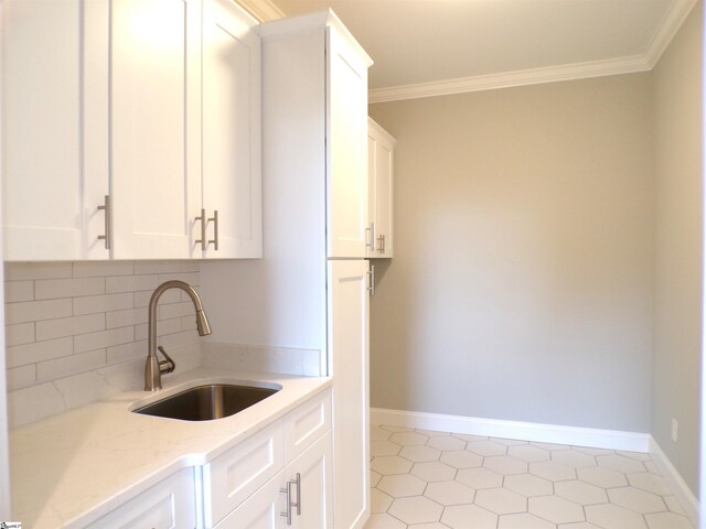 291 Robbins Rd, Chesnee, SC 29323 - kitchen with a sink, crown molding, light stone counters, white cabinetry, and decorative backsplash