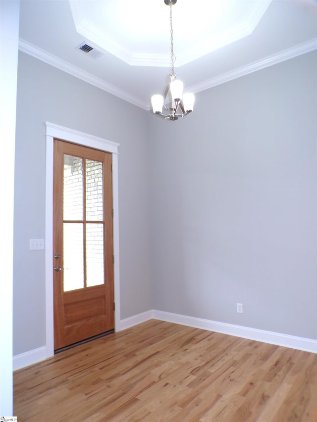 291 Robbins Rd, Chesnee, SC 29323 - empty room featuring a tray ceiling, a chandelier, light wood-style floors, baseboards, and crown molding