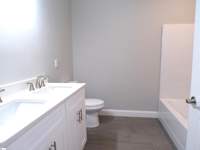 291 Robbins Rd, Chesnee, SC 29323 - bathroom with toilet, a bathtub, baseboards, double vanity, and wood finished floors