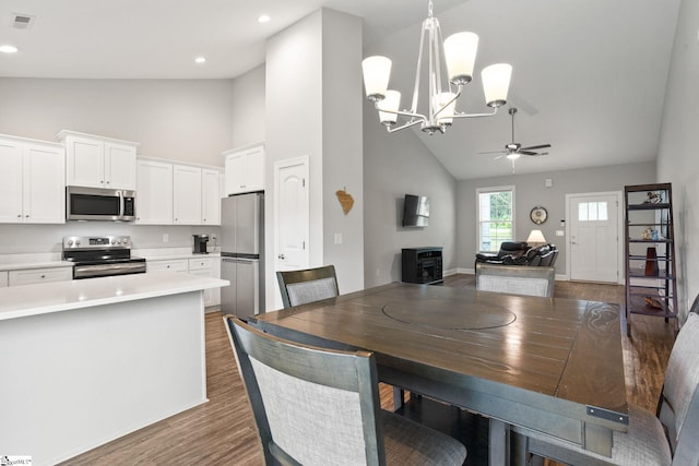 723 Mile Creek Rd, Pickens, SC 29671 - dining room with high vaulted ceiling, ceiling fan, a chandelier, dark wood-type flooring, and baseboards
