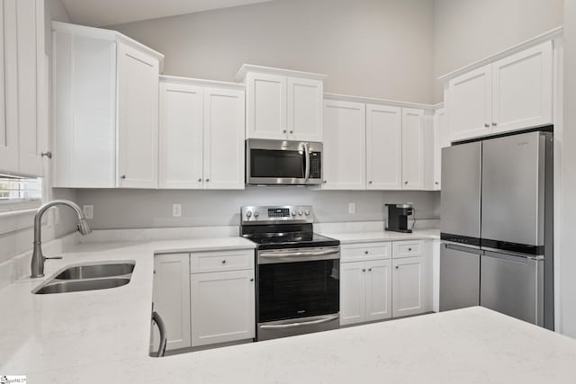 723 Mile Creek Rd, Pickens, SC 29671 - kitchen with appliances with stainless steel finishes, a sink, white cabinets, and light stone countertops