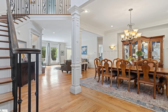 1 Riverstone Way, Greer, SC 29651 - dining space with a chandelier, light wood finished floors, crown molding, decorative columns, and stairs