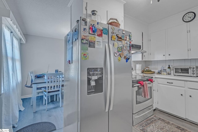 273 Cedar Springs Rd, Spartanburg, SC 29302 - kitchen featuring stainless steel appliances, light wood finished floors, white cabinets, under cabinet range hood, and a textured ceiling