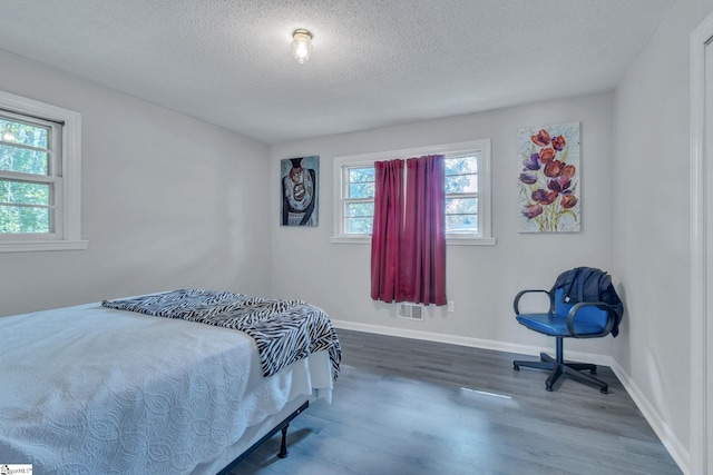 273 Cedar Springs Rd, Spartanburg, SC 29302 - bedroom featuring wood finished floors, a textured ceiling, and baseboards