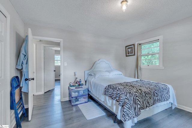 273 Cedar Springs Rd, Spartanburg, SC 29302 - bedroom with wood finished floors, a textured ceiling, and baseboards