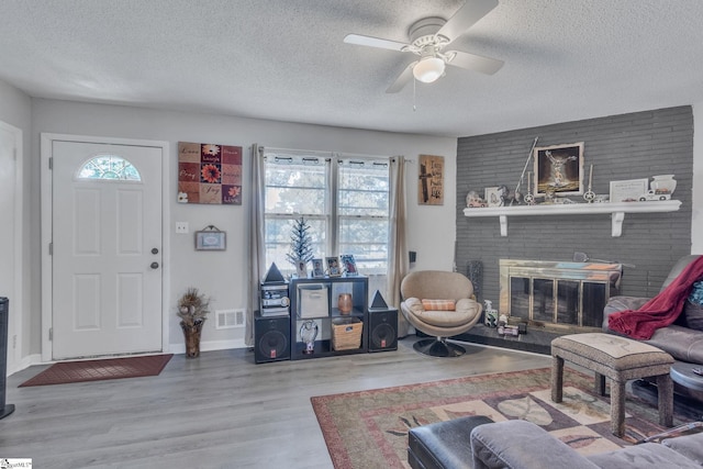 273 Cedar Springs Rd, Spartanburg, SC 29302 - living room featuring a textured ceiling, healthy amount of natural light, a ceiling fan, wood finished floors, and baseboards