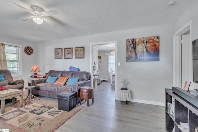 273 Cedar Springs Rd, Spartanburg, SC 29302 - living room featuring ceiling fan, a textured ceiling, light wood-type flooring, and baseboards