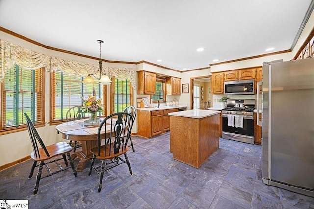 3 Staten Ln, Taylors, SC 29687 - kitchen with stainless steel appliances, ornamental molding, a center island, a sink, and light countertops